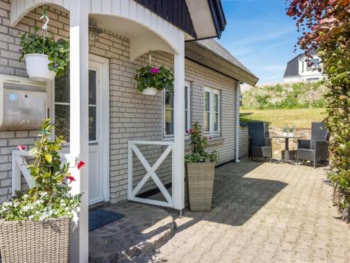a front door of a house with flowers and plants at Apartment Gilbert - 500m from the sea by Interhome in Sæby