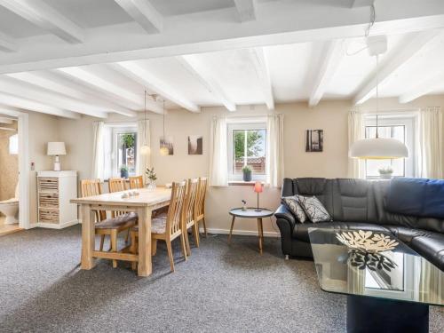 a living room with a couch and a table at Apartment Veronica - 700m from the sea by Interhome in Sæby