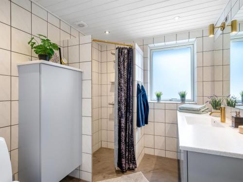 a bathroom with a shower and a sink at Holiday Home Sulo - 300m from the sea by Interhome in Blokhus