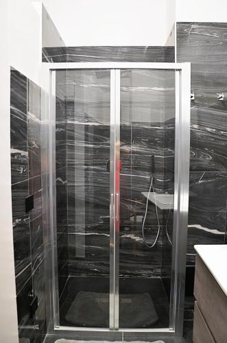 a shower with a glass door in a bathroom at Villa STEFY in Fragneto Monforte