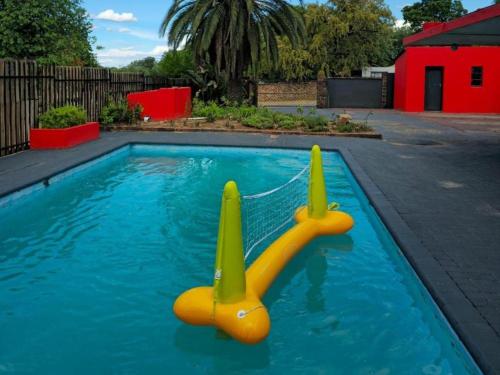 a swimming pool with a toy in the water at Bothabelo Bed and Breakfast in Phalaborwa