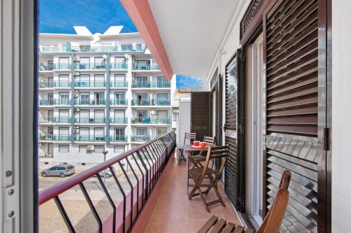 a balcony with a view of a building at Frente ao Mar in Monte Gordo