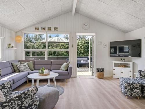 a living room with a couch and a table at Holiday Home Ema - 1-9km from the sea by Interhome in Saltum