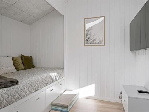 a bedroom with a bed and a picture on the wall at Holiday Home Ema - 1-9km from the sea by Interhome in Saltum