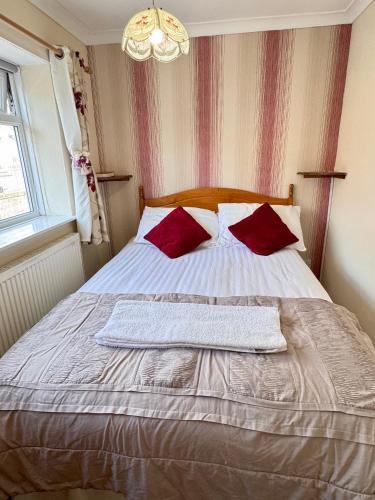 a bedroom with a bed with two towels on it at Kendal Hotel in Blackpool