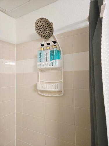 a bathroom with two bottles of soap and a shower at Frisco Vibes With Pool Gym and Elegant 1BR Apart in Frisco