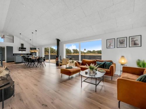 a living room with couches and a table at Holiday Home Dreng - 300m from the sea by Interhome in Harboør