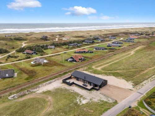 an aerial view of a house near the ocean at Holiday Home Dreng - 300m from the sea by Interhome in Harboør