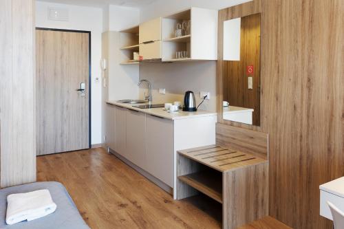 a small kitchen with a sink and a counter at Wolska Residence in Warsaw