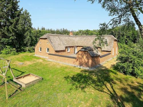 an aerial view of a house with a thatched roof at Luxury Pool House in Vester Husby - By Traum Ferienwohnungen in Husby