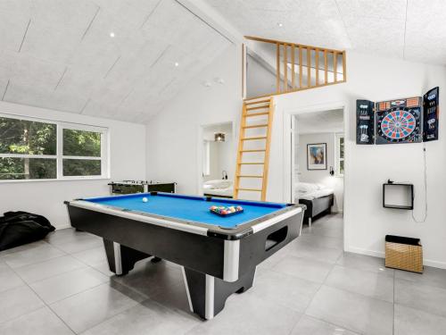 a living room with a pool table and a loft at Holiday Home Patrice - 300m from the sea by Interhome in Strøby