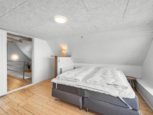 a bedroom with a large bed in a room at Holiday Home Darja - 300m from the sea by Interhome in Thyborøn