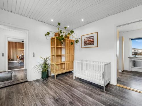 an empty living room with a crib in a room at Holiday Home Darja - 300m from the sea by Interhome in Thyborøn