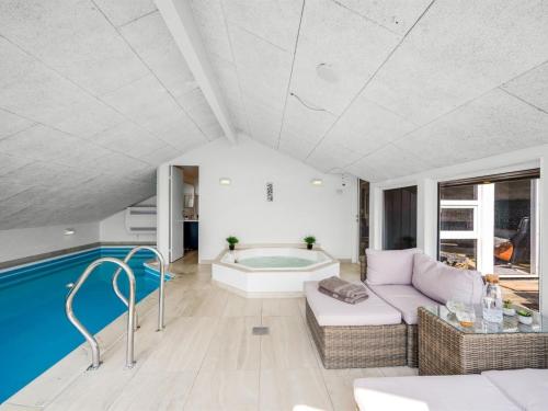a living room with a tub and a couch at Holiday Home Emin - 700m from the sea by Interhome in Vejers Strand