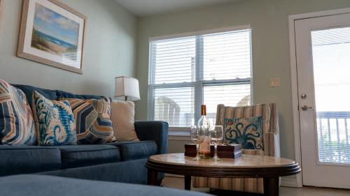 a living room with a blue couch and a table at Surfside II #109 home in Coffeyville