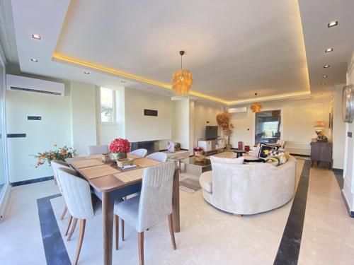 a dining room and living room with a table and chairs at Luxury Villa w Private Pool Panoramic View in Bogazici