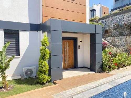 a entrance to a house with a blue door at Luxury Villa w Private Pool Panoramic View in Bogazici
