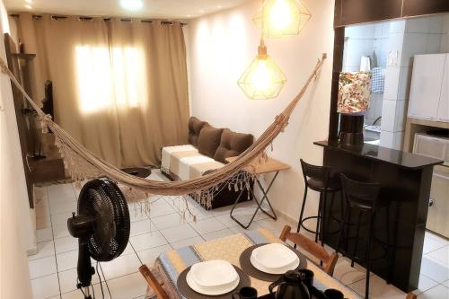 a hammock in a living room with a table and chairs at Dona Lindu 3 - Bodocongo (Campina Grande-PB) in Campina Grande