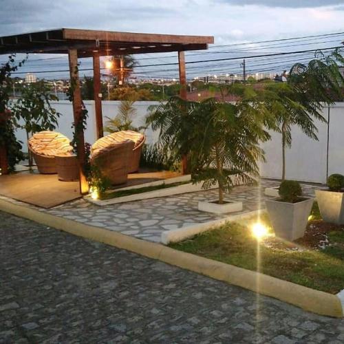 a garden with a gazebo with trees in it at Dona Lindu 3 - Bodocongo (Campina Grande-PB) in Campina Grande