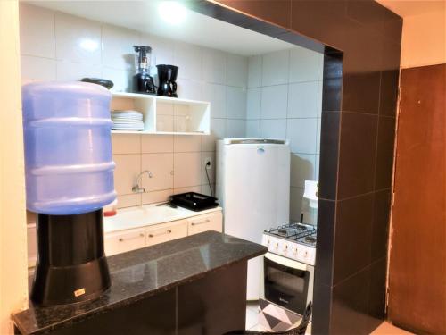 a kitchen with a large blue container on the counter at Dona Lindu 3 - Bodocongo (Campina Grande-PB) in Campina Grande