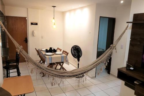 a hammock in a living room with a dining table at Dona Lindu 3 - Bodocongo (Campina Grande-PB) in Campina Grande