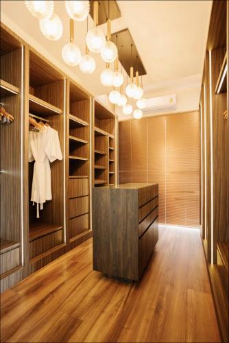 a walk in closet with wooden cabinets and a black counter at Palm Villa - Award Winning Modern Luxury & Exclusive Villa in Chiang Mai