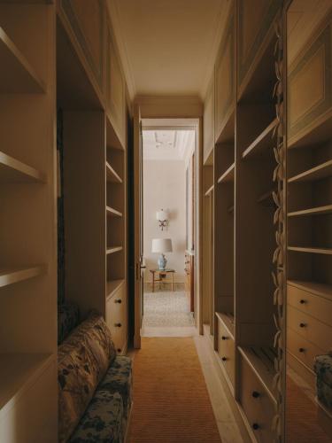 a walk in closet with a bed and a table at Grand Hotel Timeo, A Belmond Hotel, Taormina in Taormina