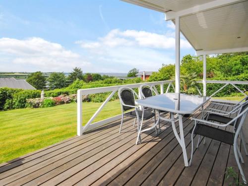 a patio with a table and chairs on a deck at Holiday Home Annabeth - 300m to the fjord by Interhome in Løgstrup