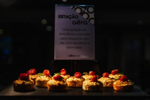 a group of cakes on a table with a sign at Aéra São José Floripa in São José
