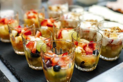 a group of glasses filled with fruit and desserts at Aéra São José Floripa in São José