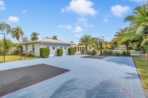 an empty driveway in front of a house at 4BR Jacuzzi, Heated Pool and Full-Size Ball Courts in Pompano Beach