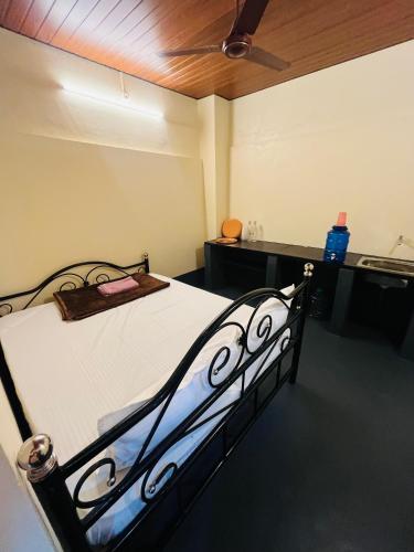 a bed in a room with a ceiling at Siilver Sands Beach Villa- Malpe Beach in Malpe
