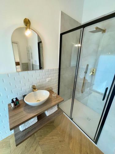 a bathroom with a sink and a shower at Fronte Reggia Apartment in Caserta