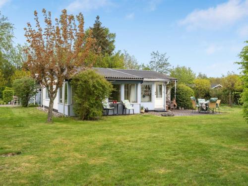 a small white house with a yard at Holiday Home Lenard - 400m from the sea by Interhome in Hals