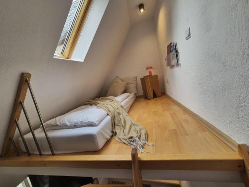 a room with a bed on a wooden floor at Ferienwohnung zur kleinen Grede in Herborn