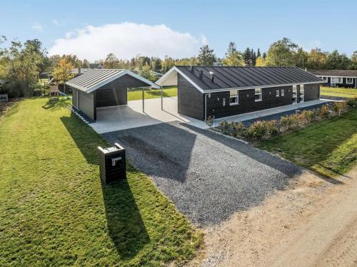 an aerial view of a black house with a yard at Holiday Home Geri - 700m from the sea by Interhome in Hals