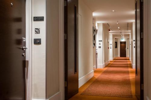 a long hallway with white walls and wooden floors and a corridorngthngthngthngth at Radisson Blu Hotel, Addis Ababa in Addis Ababa