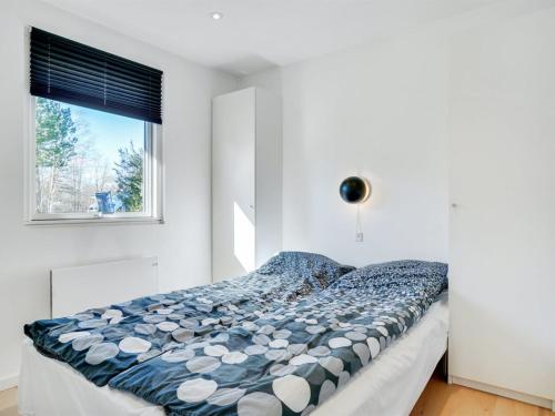 a bed in a bedroom with a window at Holiday Home Rosmarie - 600m from the sea by Interhome in Hals