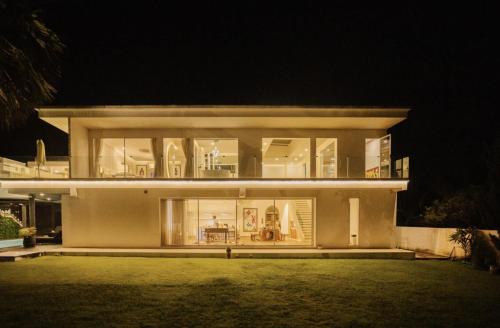 a large house at night with the lights on at Palm Villa - Award Winning Modern Luxury & Exclusive Villa in Chiang Mai