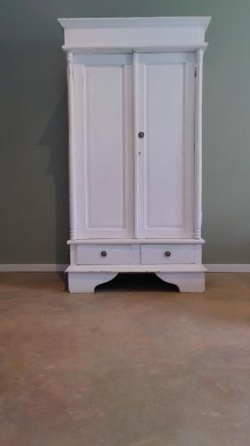a white cabinet with two doors sitting in a room at Sounds in Silence - Misty Forest Garden in Balgowan