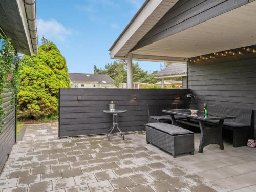 a patio with a table and chairs and a fence at Holiday Home Jurien - 450m from the sea by Interhome in Hals