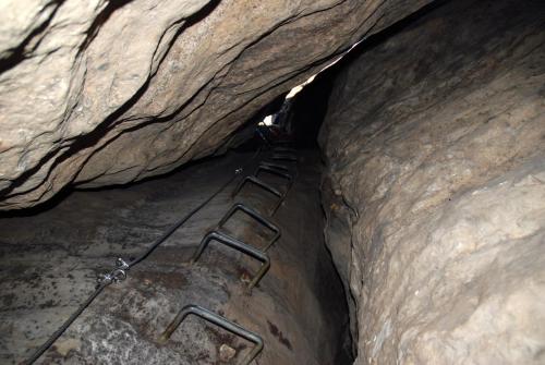 a rock cave with a ladder in the middle of it at Ferienwohnung am Wäldchen in Kurort Gohrisch