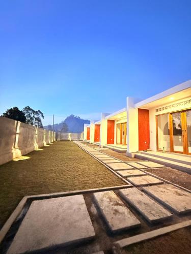 a row of buildings next to a fence at Talvista Kintamani Villa in Kintamani