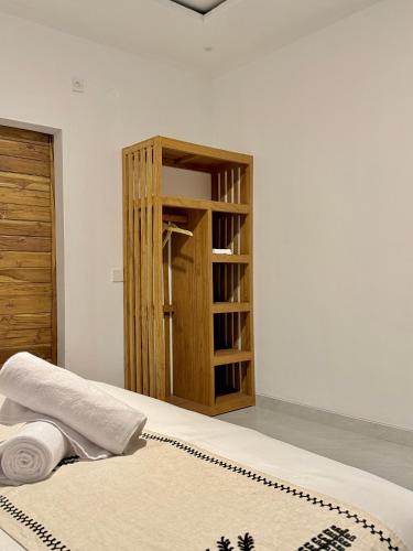 a bedroom with a book shelf and a bed at Talvista Kintamani Villa in Kintamani