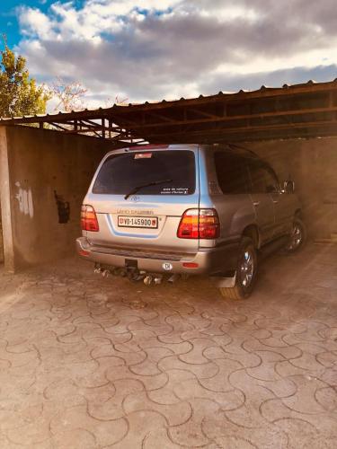 a minivan parked next to a building at Résidence Lafatra in Mandrangobato