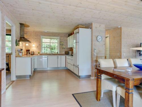 a kitchen with a table and a dining room at Holiday Home Tian - from the sea by Interhome in Hadsund