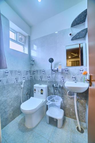 a bathroom with a toilet and a sink at Arrival Inn Transit Hotel Bangalore Airport in Bangalore