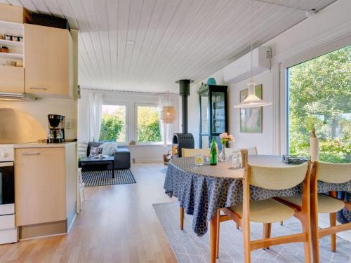 a kitchen and living room with a table and chairs at Holiday Home Savina - from the sea by Interhome in Hadsund