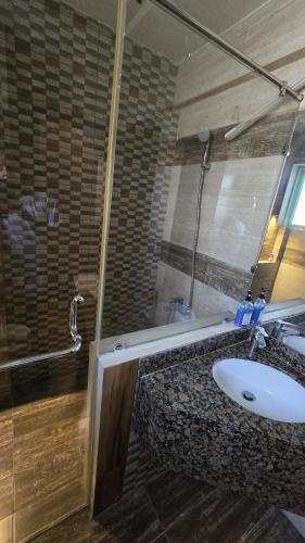 a bathroom with a sink and a bath tub at Home Sweet Home in Karachi