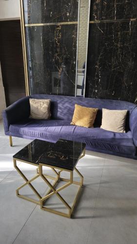 a purple couch and a coffee table in a room at Home Sweet Home in Karachi